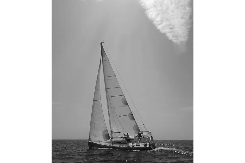 Slide: The Image of Sailing yacht Figaro Beneteau 2, 2003 model, gliding on open sea under clear skies. - 26