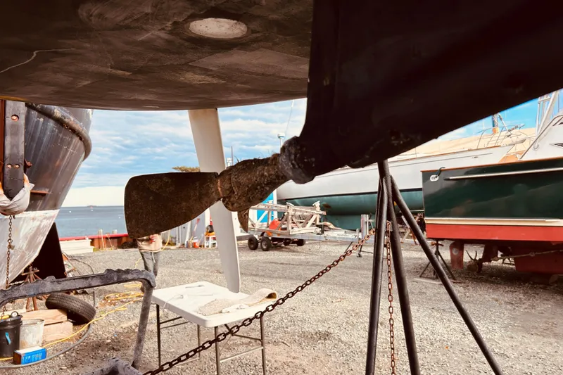 Slide: The Image of Beneteau Figaro Beneteau 2 sailboat propeller and rudder in a boatyard, 2003 model. - 29