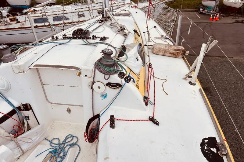 Slide: The Image of 2003 Beneteau Figaro Beneteau 2 sailboat deck with ropes and winches. - 6