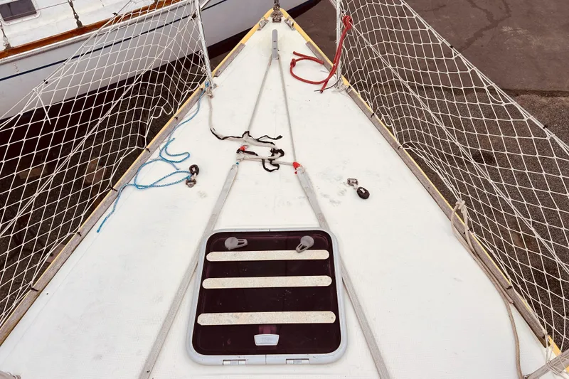 Slide: The Image of Deck of 2003 Beneteau Figaro 2 sailboat with netting and ropes. - 8