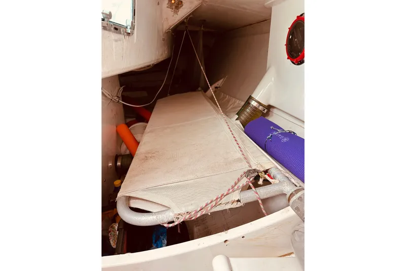 Slide: The Image of Interior of 2003 Beneteau Figaro 2 sailboat, featuring a compact sleeping berth. - 16