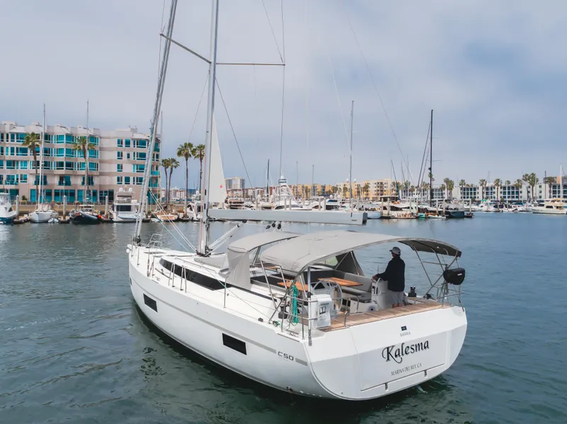 Slide: The Image of 2021 Bavaria C50 Style yacht in marina, calm waters, modern design, overcast sky. - 14