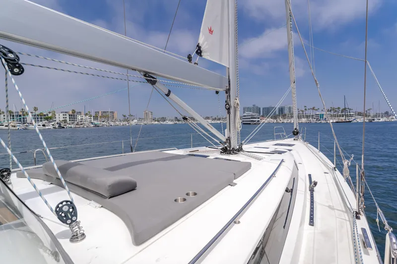 Slide: The Image of 2021 Bavaria C50 Style yacht sailing in a marina under a clear blue sky. - 21