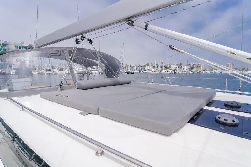Slide: The Image of 2021 Bavaria C50 Style yacht with spacious deck and sunbathing area in marina. - 22