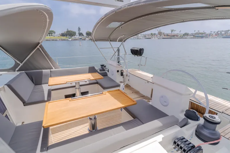 Slide: The Image of Luxurious 2021 Bavaria C50 Style yacht deck with seating and tables, overlooking serene waters. - 28