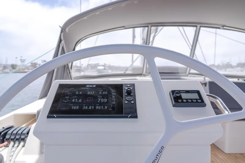 Slide: The Image of 2021 Bavaria C50 Style yacht helm with navigation display and controls. - 31