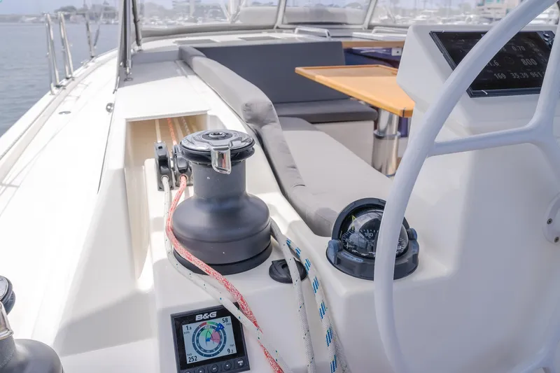 Slide: The Image of 2021 Bavaria C50 Style yacht cockpit with winch, ropes, and navigation display. - 32