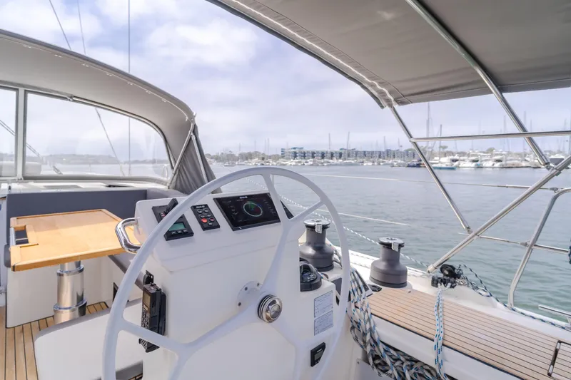 Slide: The Image of 2021 Bavaria C50 Style yacht cockpit with steering wheel, marina view, and modern design. - 34