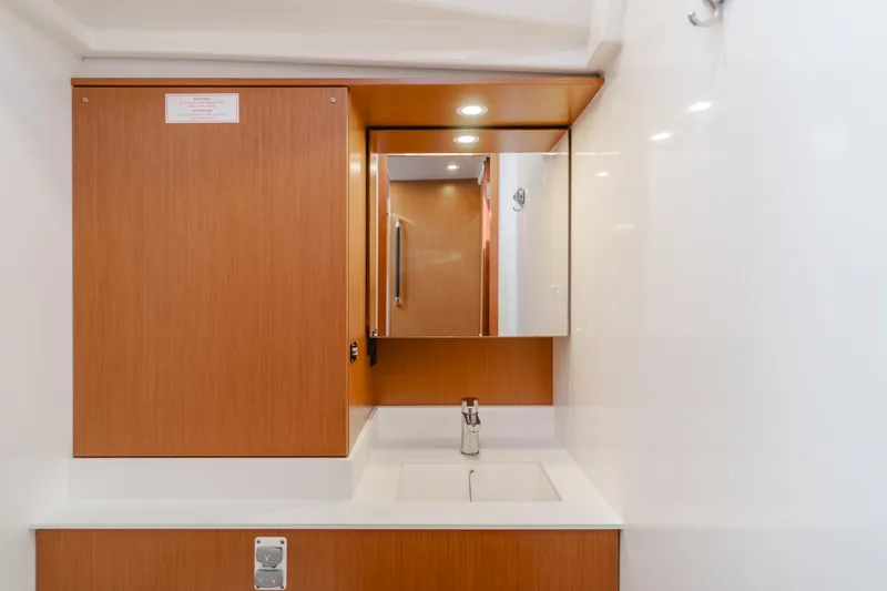 Slide: The Image of Modern bathroom vanity in 2021 Bavaria C50 Style yacht, featuring wood cabinetry and sleek design. - 49