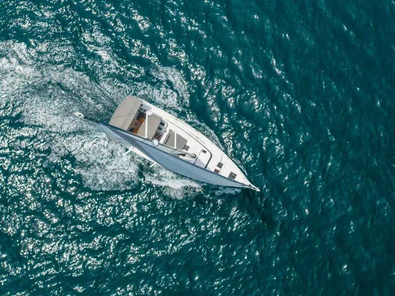 Slide: The Image of Aerial view of 2021 Bavaria C50 Style yacht sailing on blue ocean waters. - 7