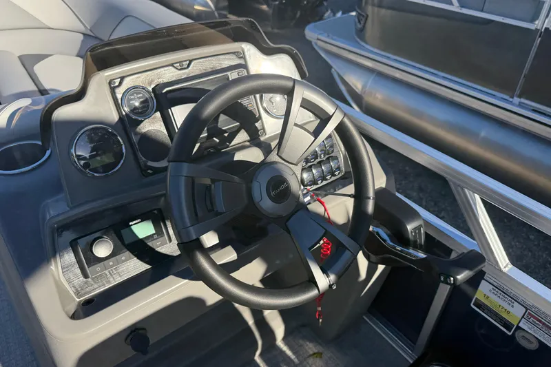 Slide: The Image of Steering console of 2026 Tahoe Pontoon Sport 85 Rear Fish boat, featuring modern controls. - 5