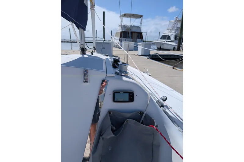Slide: The Image of 2013 Catalina 22 Capri sailboat docked, featuring deck details and rigging. - 2