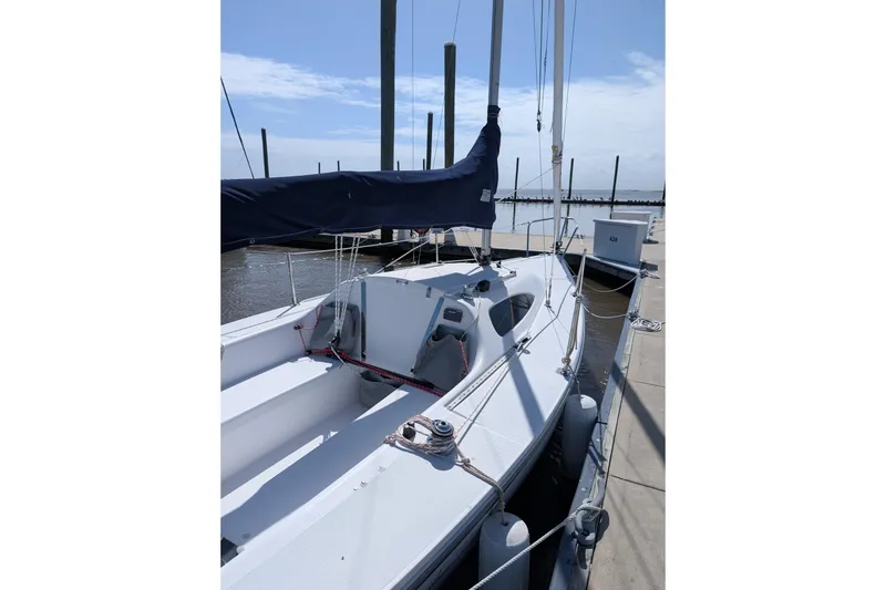 Slide: The Image of 2013 Catalina 22 Capri sailboat docked at marina under clear sky. - 3