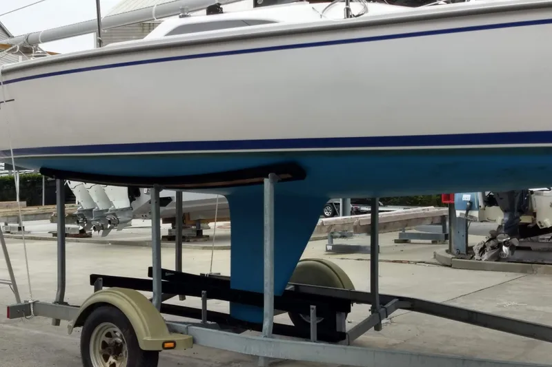 Slide: The Image of 2013 Catalina 22 Capri sailboat on trailer, displayed in a marina setting. - 6