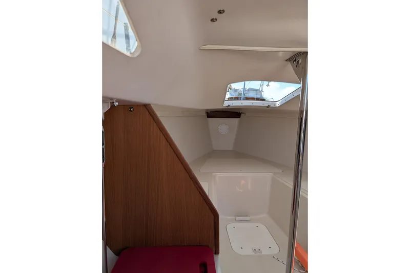 Slide: The Image of Interior cabin of a 2013 Catalina 22 Capri sailboat, featuring wood paneling and a skylight. - 7