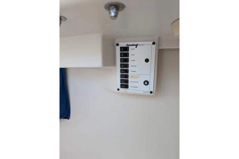 Slide: The Image of Control panel on a 2013 Catalina 22 Capri sailboat, featuring labeled switches. - 9