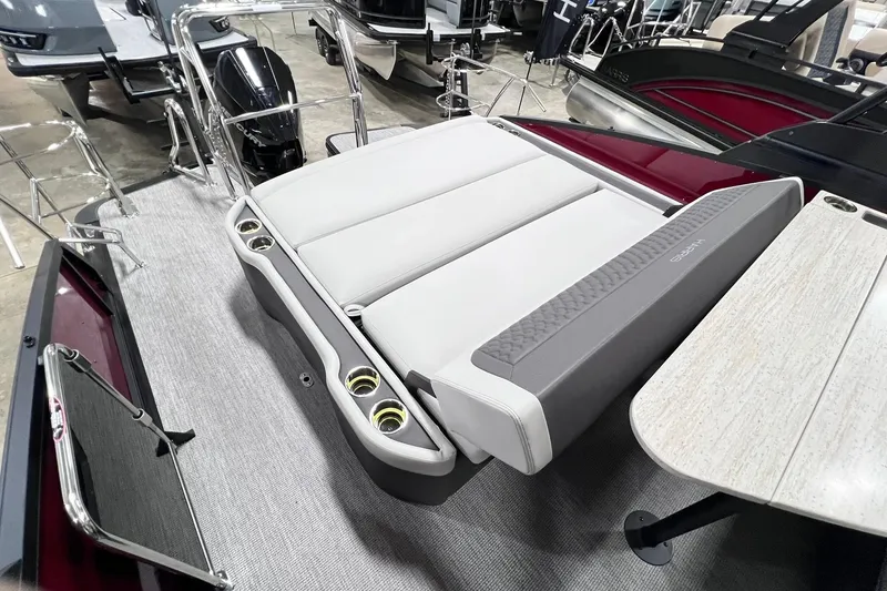 Slide: The Image of 2026 Harris Sunliner 250 SLE boat interior with seating and table, showcasing modern design. - 25
