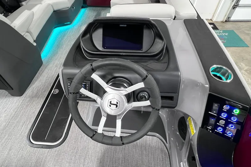 Slide: The Image of Steering console of 2026 Harris Sunliner 250 SLE with illuminated controls and modern design. - 26