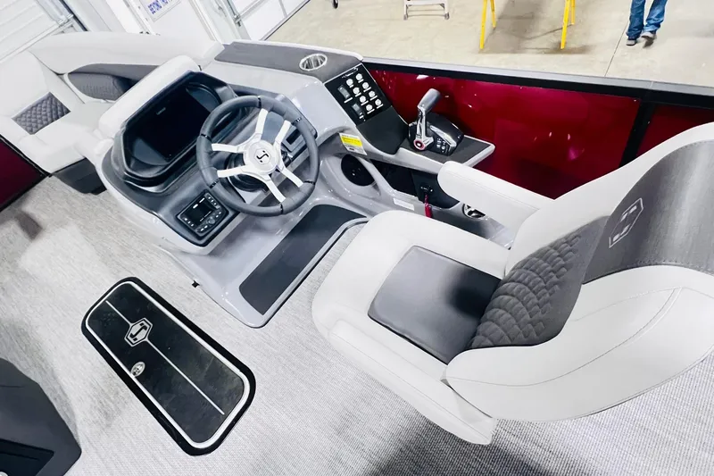 Slide: The Image of Interior view of 2026 Harris Sunliner 250 SLE boat, featuring modern steering and seating. - 29