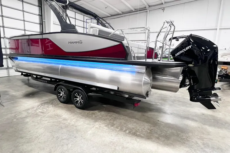 Slide: The Image of 2026 Harris Sunliner 250 SLE pontoon boat with Mercury engine in a showroom. - 3