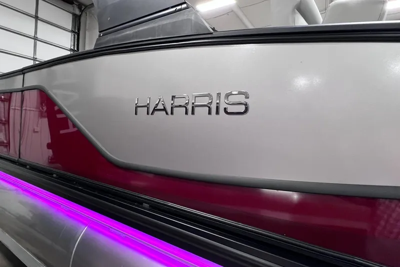 Slide: The Image of 2026 Harris Sunliner 250 SLE pontoon boat with sleek design and purple LED lighting. - 34