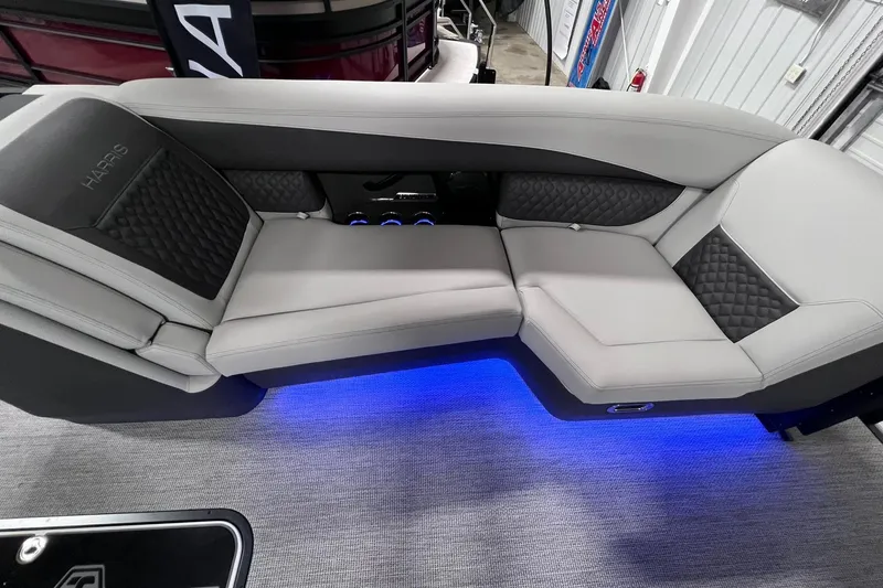 Slide: The Image of Luxurious seating on 2026 Harris Sunliner 250 SLE with ambient blue lighting. - 36