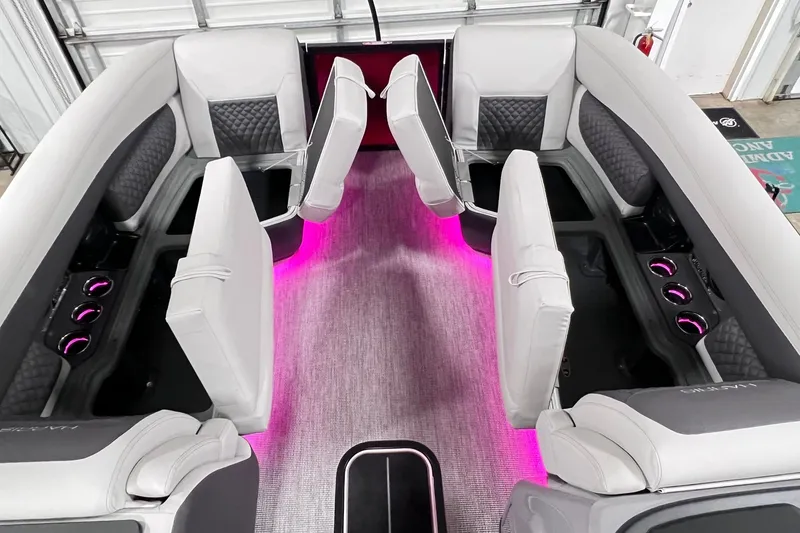 Slide: The Image of Luxurious interior of 2026 Harris Sunliner 250 SLE with ambient pink lighting and plush seating. - 40