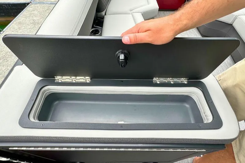 Slide: The Image of Open storage compartment on 2026 Harris Sunliner 250 SLE boat, showcasing interior space. - 45