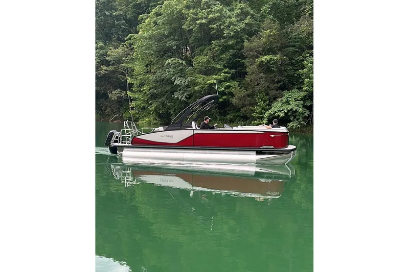 Slide: The Image of 2026 Harris Sunliner 250 SLE pontoon boat cruising on a serene lake. - 5
