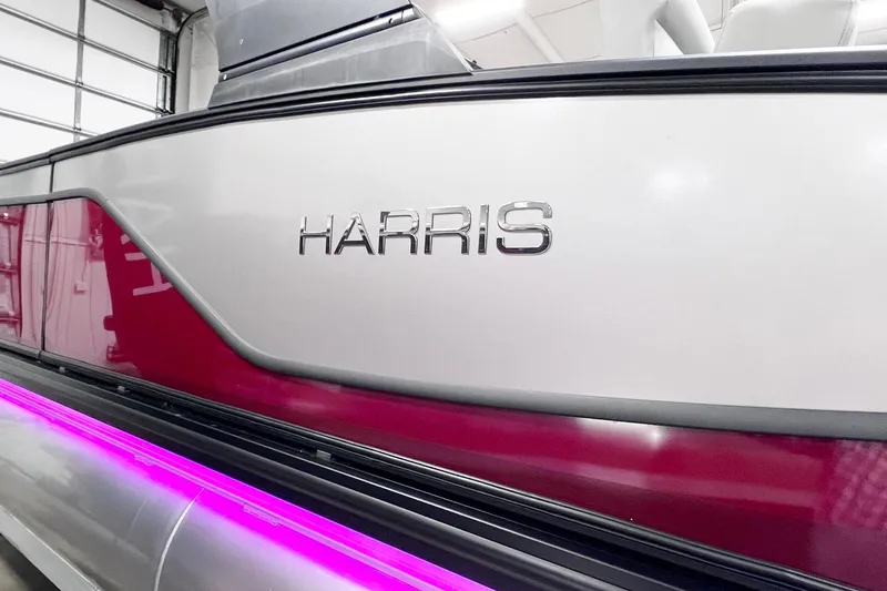 Slide: The Image of 2026 Harris Sunliner 250 SLE pontoon boat with sleek design and vibrant pink accent lighting. - 51