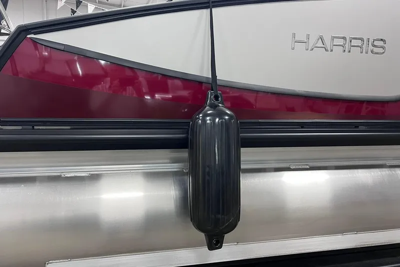 Slide: The Image of 2026 Harris Sunliner 250 SLE pontoon boat with maroon and silver exterior. - 53