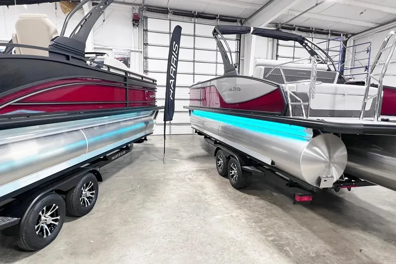 Slide: The Image of 2026 Harris Sunliner 250 SLE pontoon boats displayed in a showroom. - 58