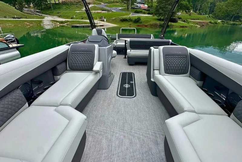 Slide: The Image of Luxurious interior of 2026 Harris Sunliner 250 SLE pontoon boat on a serene lake. - 8