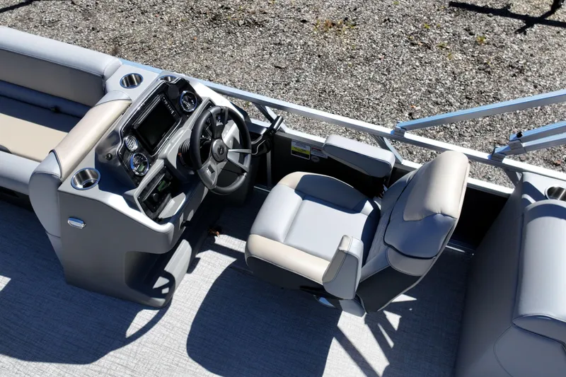 Slide: The Image of 2026 Tahoe Pontoon Sport 85 Quad Lounger helm with modern steering and seating. - 3