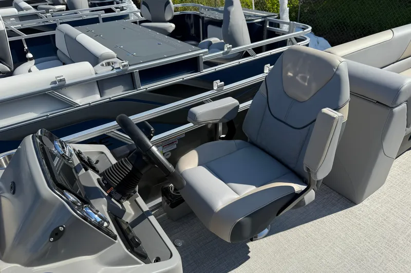 Slide: The Image of 2026 Tahoe Pontoon Sport 85 Quad Lounger interior with steering console and seating. - 9