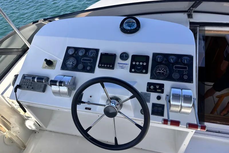 Slide: The Image of Cockpit of 1998 Navigator 4800 yacht with steering wheel and control panel. - 12