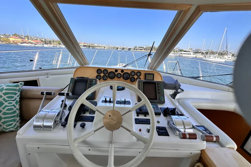 Slide: The Image of Cockpit view of 1998 Navigator 4800 yacht with steering wheel and control panels. - 13
