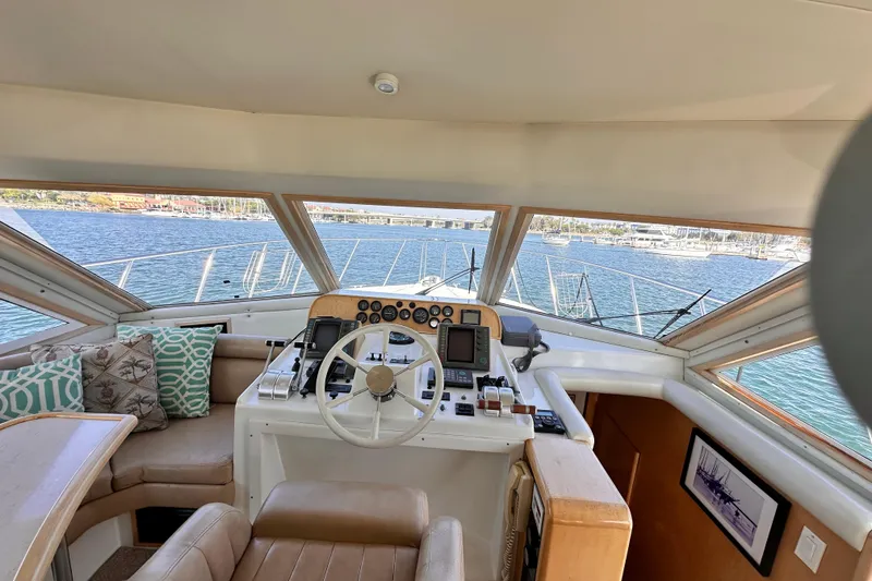 Slide: The Image of Interior view of 1998 Navigator 4800 yacht helm with panoramic windows and plush seating. - 14