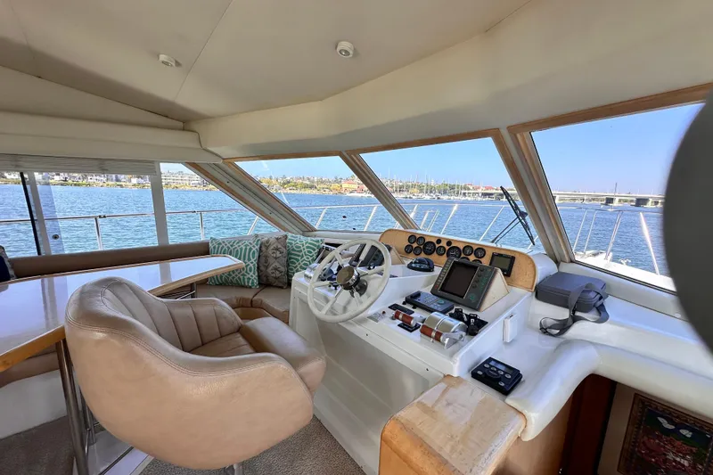 Slide: The Image of Interior view of 1998 Navigator 4800 yacht helm with leather seating and navigation equipment. - 15