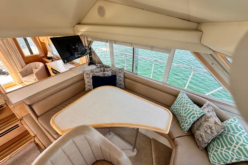 Slide: The Image of Luxurious 1998 Navigator 4800 yacht interior with cozy seating and scenic water view. - 16