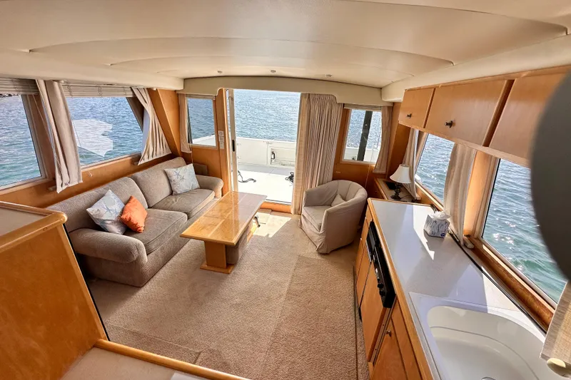 Slide: The Image of Luxurious interior of 1998 Navigator 4800 yacht with cozy seating and ocean view. - 17