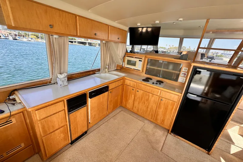 Slide: The Image of Navigator 4800 yacht kitchen interior, 1998 model, featuring wood cabinetry and modern appliances. - 19