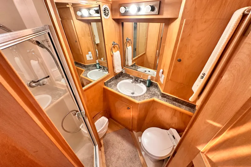 Slide: The Image of Compact 1998 Navigator 4800 bathroom with shower, sink, and toilet in wooden interior. - 22