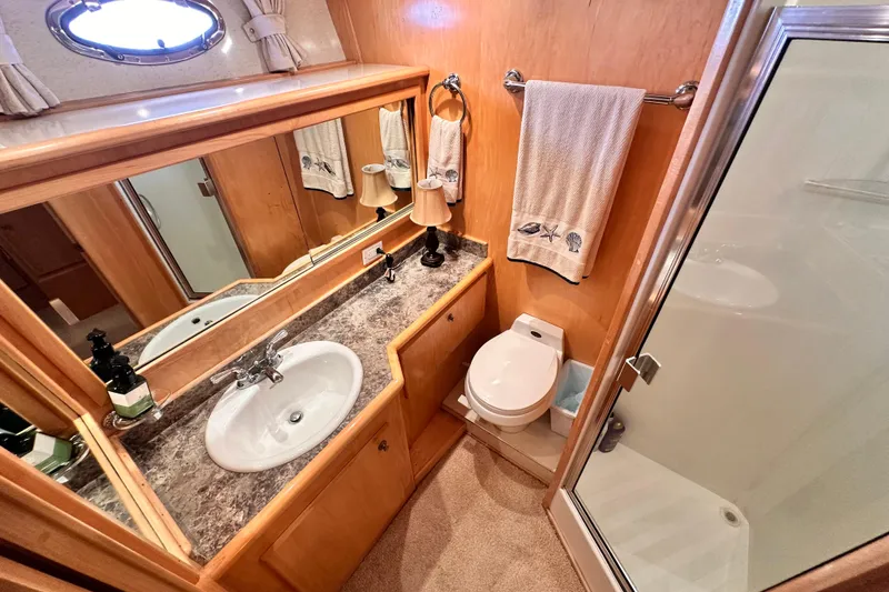 Slide: The Image of Luxurious 1998 Navigator 4800 yacht bathroom with sink, toilet, and shower. - 25