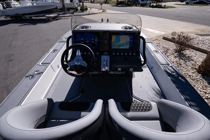 Slide: The Image of Turner Boatworks 2026 24 SAVAGE dashboard with dual seats and navigation display. - 23