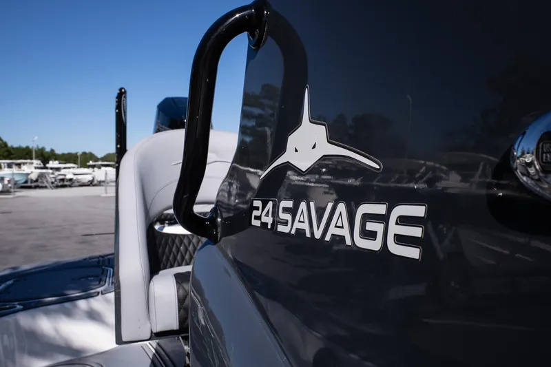 Slide: The Image of 2026 Turner Boatworks 24 SAVAGE logo on sleek black boat exterior. - 26