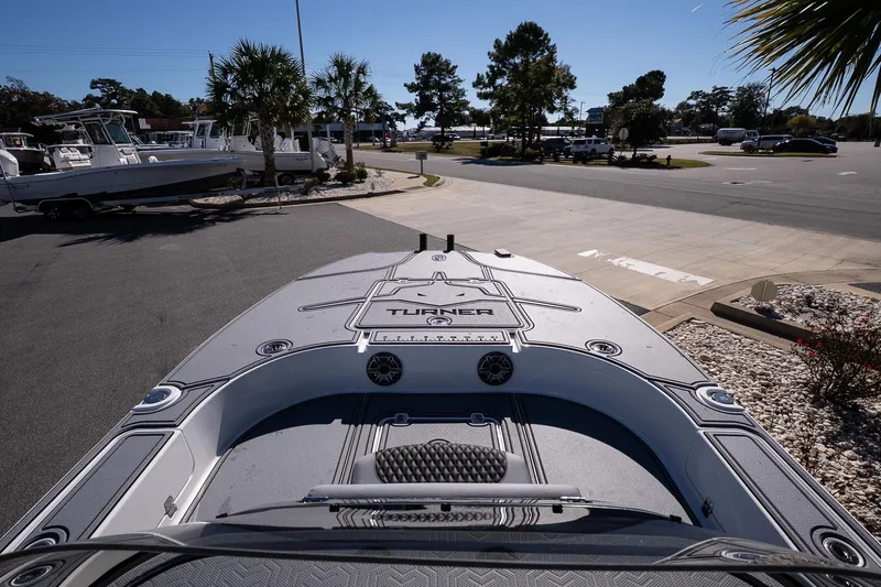 Slide: The Image of 2026 Turner Boatworks 24 SAVAGE boat on display in a sunny outdoor setting. - 27