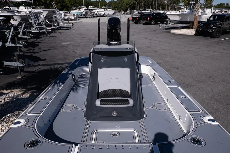 Slide: The Image of 2026 Turner Boatworks 24 SAVAGE in a boatyard, showcasing sleek design and spacious deck. - 29