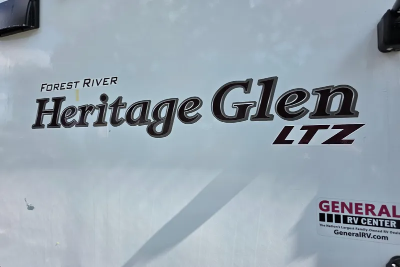 Slide: The Image of 2018 Heritage Glen 356QB RV exterior with Forest River branding and General RV Center sticker. - 10