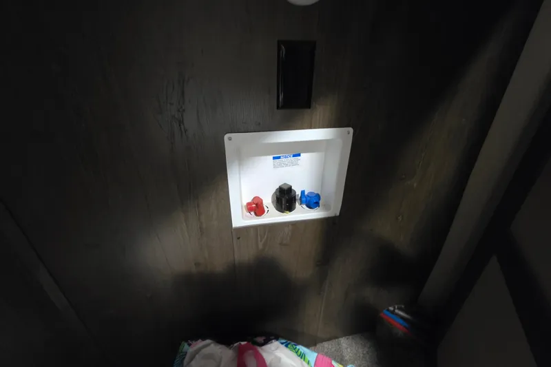 Slide: The Image of 2018 Heritage Glen 356QB RV water hookup panel on wooden wall. - 16